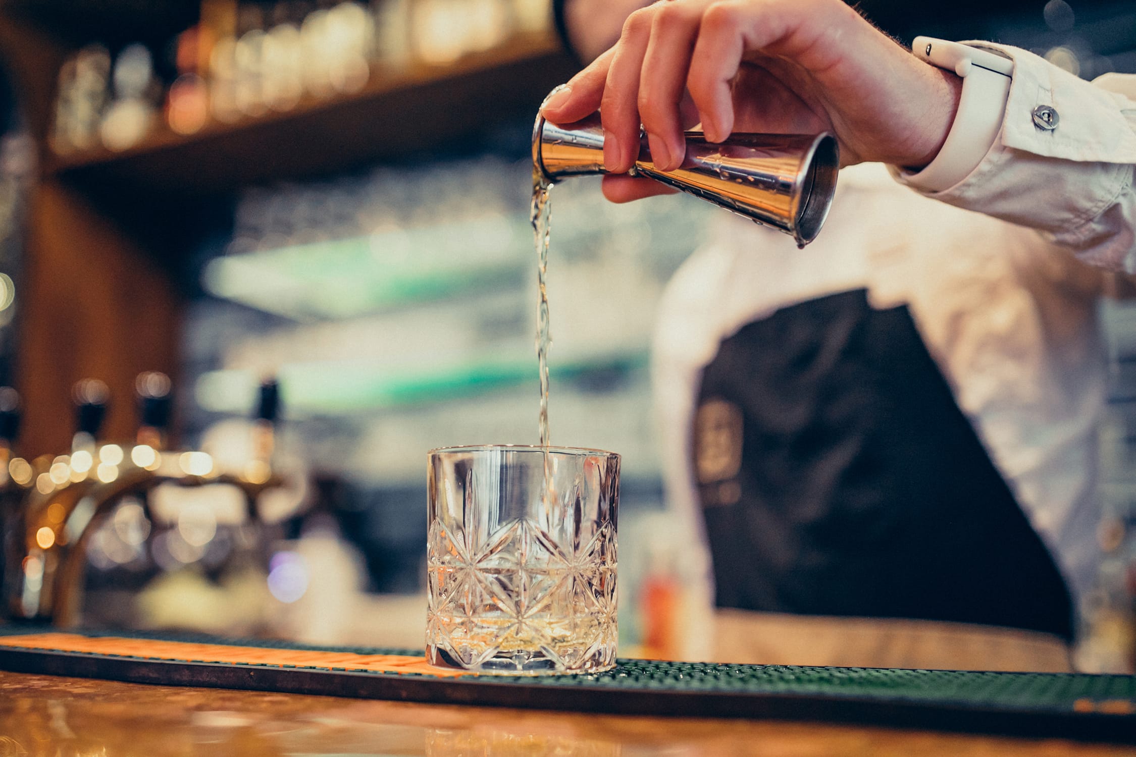 handsome-bartender-making-drinking-cocktails-counter